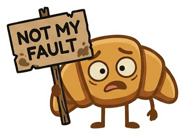 The croissant mascot holding a sign reading "Not my fault".